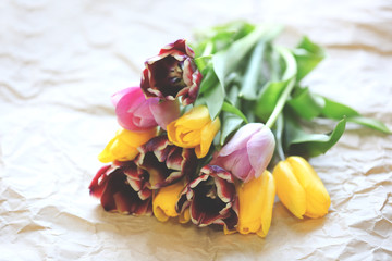 Obraz na płótnie Canvas Bouquet of fresh tulips on a craft paper