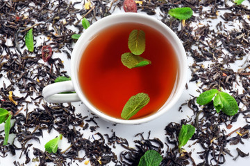 Cup of tea with dry leaves, top view