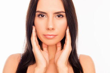 Portrait of serious attractive girl touching her face