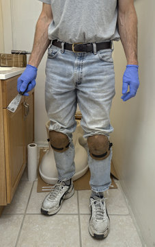 Handyman plumber installing new toilet