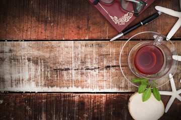 Cup of tea and mint on a wooden background