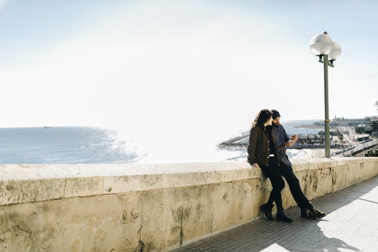 Spain, Tarragona, city break, young couple talking