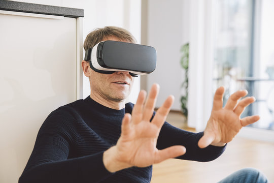 Man wearing virtual reality glasses using his hands