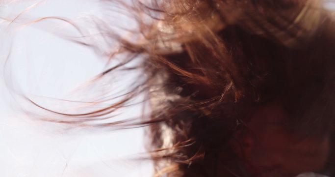 Close up of hair moved by the wind on a sunny day