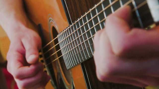 Playing an Acoustic Guitar - Close Up Fretboard