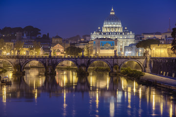 Fototapeta na wymiar St. Peter's cathedral (Basilica di San Pietro) and bridge over river Tiber in the morning before sunrise, Rome, Italy, Europe 