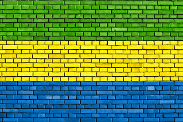 flag of Gabon painted on brick wall