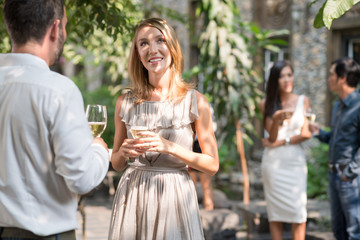 Pretty woman talking with male guest at the party