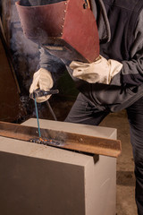 Welder working factory welding the metal