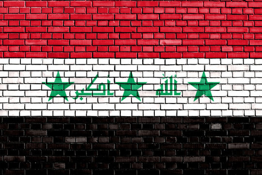 flag of Iraq painted on brick wall