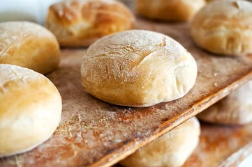 Fotobehang Freshly baked round loaves of white bread © photology1971