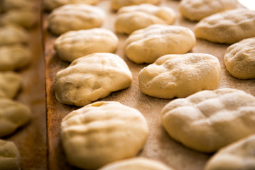 Preparing fresh loaves of bread in a bakery