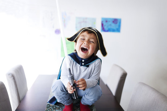 Portrait of laughing little boy dressed up as a pirate