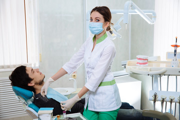 Fototapeta premium Dentist woman doing the procedure in the dental office