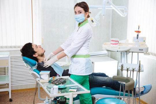 Dentist woman doing the procedure in the dental office