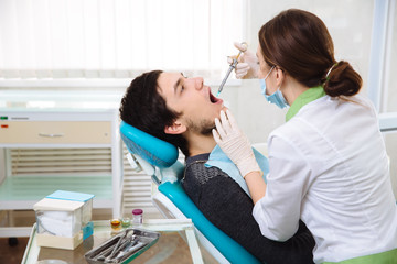 Fototapeta na wymiar Dentist woman doing the procedure in the dental office