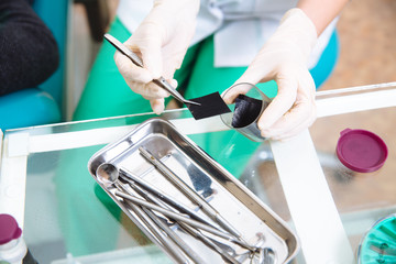 Medical tools in doctor hands. Dentist equipment