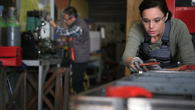 Metalworker woman in workshop