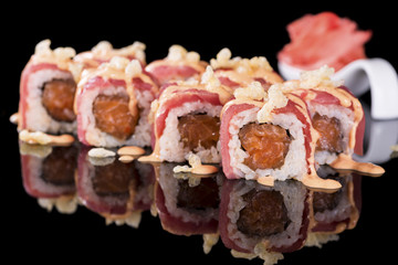 Sushi Roll with salmon and ginger over  black background with re