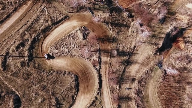 Utv car makes turns on the track. Top view from drone.