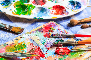 Colourful oil paint, different types of  brushes and palette