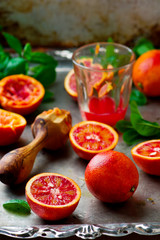 the fresh bloody oranges cut in half on a vintage metal tray.