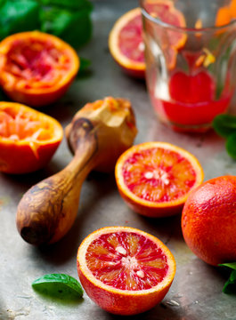 the fresh bloody oranges cut in half on a vintage metal tray.