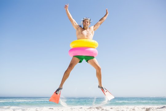 Smiling Man Jumping With Rubber Ring