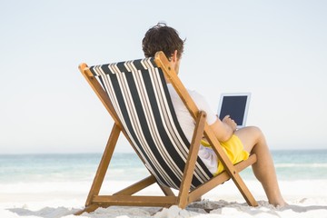 Man relaxing and using tablet