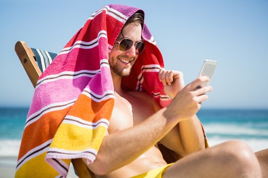 Man relaxing and using smartphone - Powered by Adobe