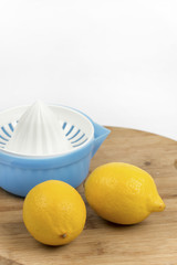 Lemons and strainer on a wooden board