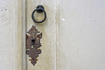 Old door knocker in closed door
