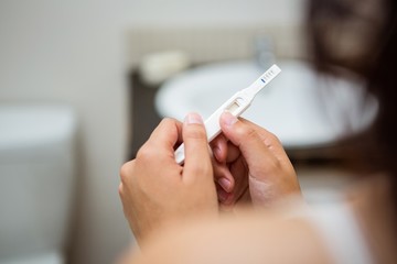 Obraz na płótnie Canvas Woman holding a pregnancy test