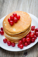 Stack of pancakes with blueberry and fresh berry.