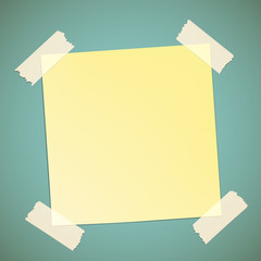 Yellow sticker pasted to the wall with adhesive tape.