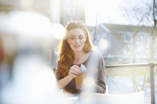 Young woman taking notes out of her purse