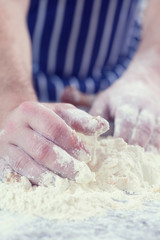 Close up of chef kneading dough