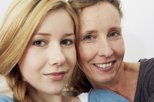 Portrait of mother and daughter head to head