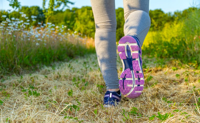 Woman running at sunset in a field