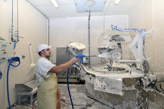 Worker disinfecting interior of a butchery