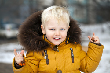 Close up portrait, little boy in a winter park