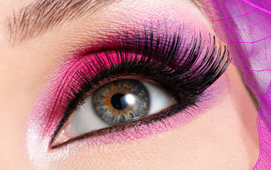 female eye with  beautiful fashion bright pink makeup