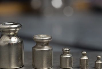 Plummets set on weigh-scales. Jewelry workplace on metal background with copy space for text.