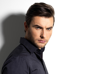 Fashion portrait of young man in black shirt