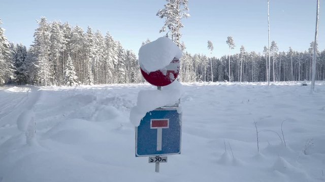 The street sign covered with thick snow on a winter season. The thick snow covering the street in Estonia