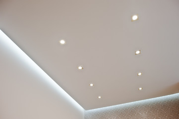 Eight golden lighting lamps built into the ceiling turn on with