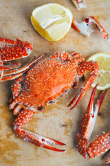 Crabs and lemon on wooden board