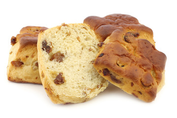 traditional english scones with raisins and a cut one on a white background
