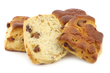 traditional english scones with raisins and a cut one on a white background
