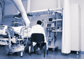 Fototapeta premium Doctor with stethoscope striding in a hospital ward